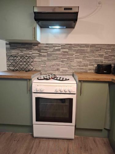 a white stove top oven in a kitchen at Perfect Gites In Normandy - New Beginnings Barn in Saint-Sauveur-de-Chaulieu