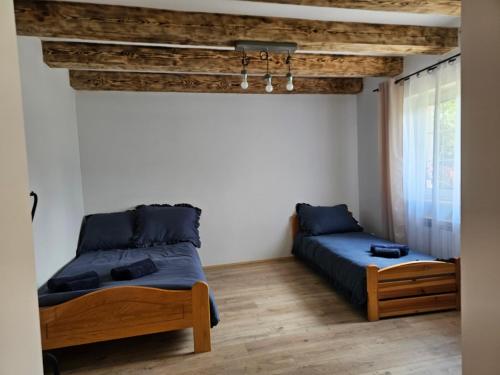 a bedroom with two beds and a window at Przy potoku in Średnia Wieś