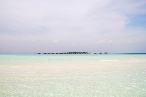 a view of the ocean with an island in the distance at Kaafu Inn Guraidhoo in Guraidhoo