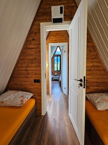 a attic room with two beds and a hallway at B&B Cottage in Mestia in Mestia