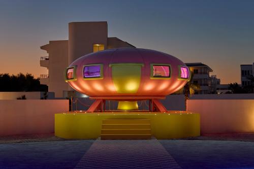 a object shaped like a house with lights on it at Los Felices Ibiza in San Antonio Bay