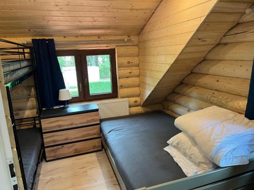 a bedroom with a bunk bed and a desk at Domek nad jeziorem Agnieszka i Radek Sieczkowscy in Harsz