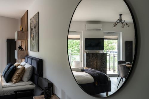 a bedroom with a bed and a mirror at RentPlanet - Kępa Mieszczańska in Wrocław