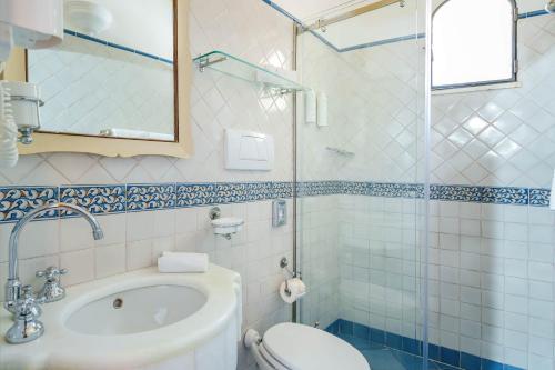 a bathroom with a sink and a toilet and a shower at Albergo Miramare Positano in Positano