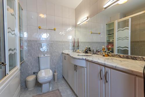 a bathroom with a toilet and a sink and a mirror at Selimiye Meltem's in Marmaris