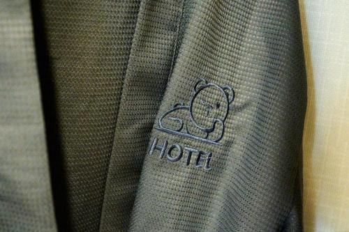 a close up of a hilton sign on a suit at Hyuzen Hotel - 휴젠 in Seoul