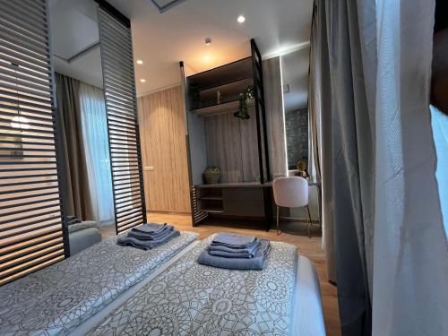 a bedroom with a bed with towels on it at Vienna Charm Apartments Meidling in Vienna