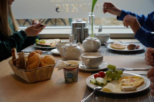 a table with plates of food and bread on it at Hotel Oepkes in West-Terschelling