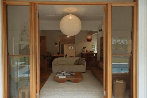 a living room with a couch and a table at Herrings House, an iconic designer nature retreat in Willunga