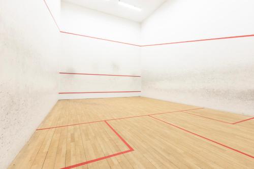 an empty gymnasium with a wooden basketball court at Gloucester Robinswood Hotel, BW Signature Collection in Gloucester
