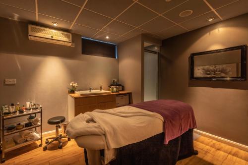 a bathroom with a sink and a bed in a room at Gloucester Robinswood Hotel, BW Signature Collection in Gloucester
