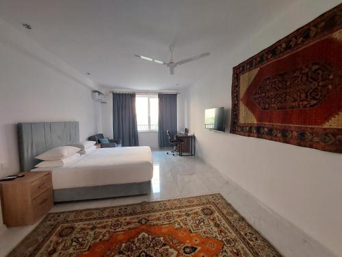 a bedroom with a bed and a rug on the wall at Areni Lodge in Areni