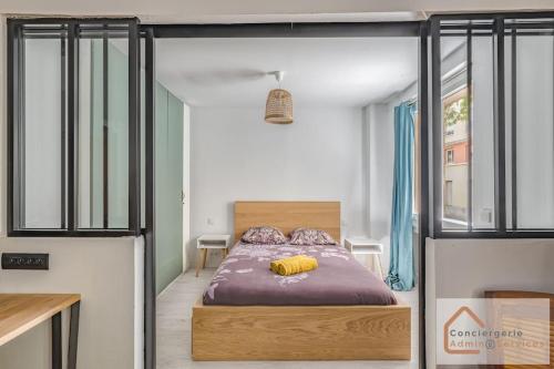 une chambre avec un lit avec des oreillers jaunes dessus dans l'établissement Évasion Urbaine - Confort Moderne pour 4 Voyageurs, à Lyon