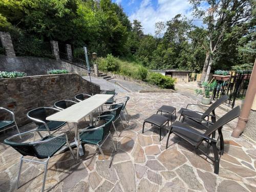 a patio with a table and chairs on a stone patio at Almschlössl in Baden