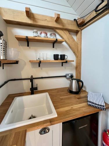 a kitchen with a sink in a tiny house at The Barn Mid Bedfordshire in Haynes
