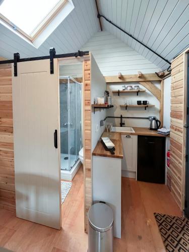 a kitchen with a sliding door in a room at The Barn Mid Bedfordshire in Haynes