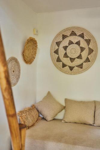 a room with some pillows and a wall with at 360 Surf Camp in Kuta Lombok
