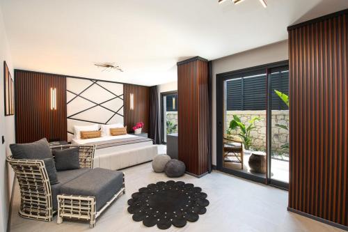 a bedroom with a bed and a couch and a chair at The Grey Alaçatı in Çeşme