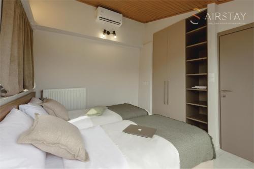 a bedroom with a bed with a laptop on it at Akali Apartment airport by Airstay in Spáta