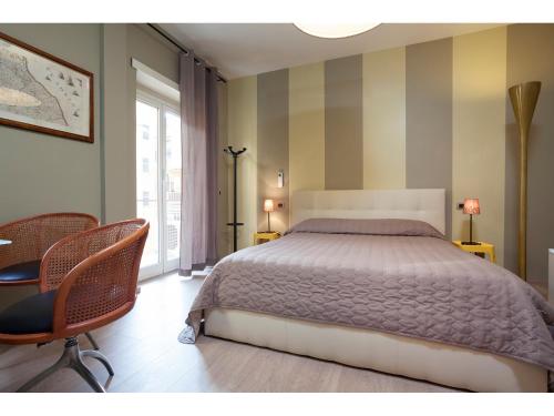 - une chambre avec un lit, des chaises et une fenêtre dans l'établissement Alex's Guest House, à Rome