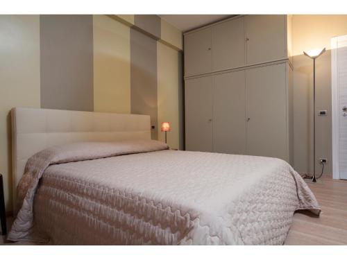a bedroom with a bed with a white bedspread at Alex's Guest House in Rome