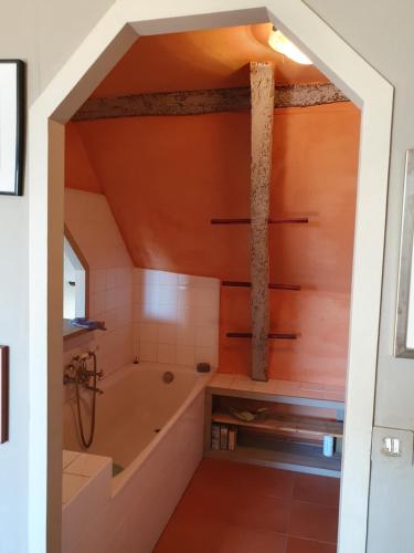 La salle de bains mansardée est pourvue d'une baignoire et d'un lavabo. dans l'établissement Sur le balcon des marais salants, à Guérande