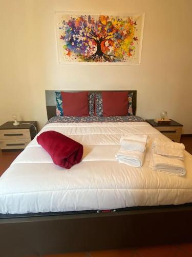 a bedroom with a large bed with towels on it at Host San Pietro in Formigine