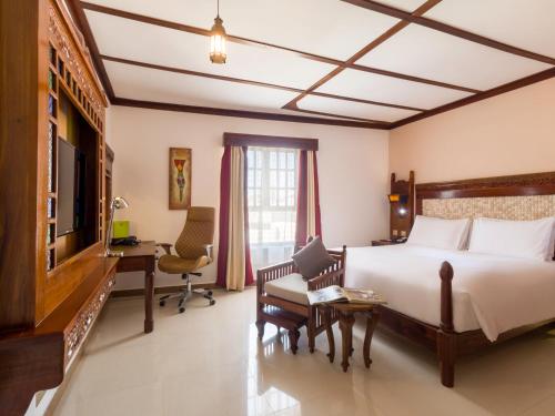 a hotel room with a bed and a desk at Spice Tree by Turaco in Zanzibar City