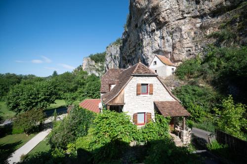a house on the side of a mountain at Logis Hôtels - Hôtel Restaurant Domaine Les Falaises in Martel