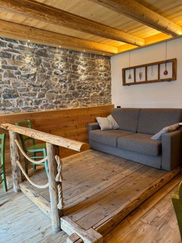 a living room with a couch and a table at Appartamenti al Ciariè in Cima Gogna