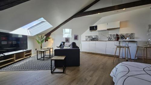 un salon avec un canapé et une cuisine dans l'établissement Maison Saint Surin, à Limoges