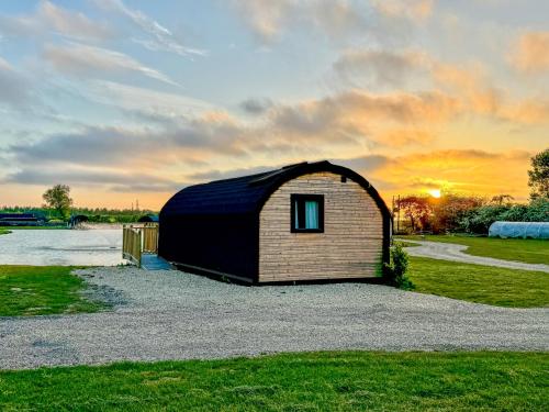 a small building with a dome roof on a field at The Firs Country Park in Boston