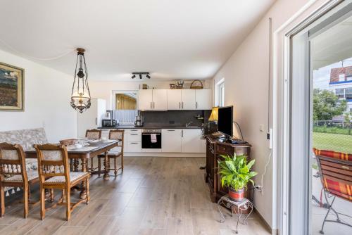 a kitchen and dining room with a table and chairs at Haus Kellenburg in Albstadt