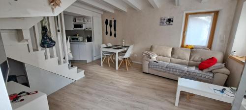 a living room with a couch and a table at Chalet BORGO PRA' in Belluno