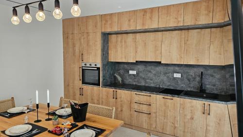a kitchen with a table and a stove top oven at Kooba Villas in Gázion