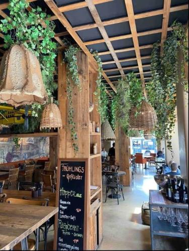 a restaurant with plants hanging from the ceiling at KAYA Zurich Apartment 1B - Deluxe 2BR Downtown Apt in Zürich