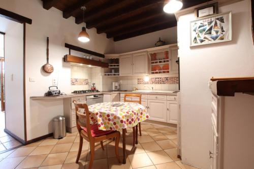 a kitchen with a table and chairs in a room at Mentaxuria in Mendionde
