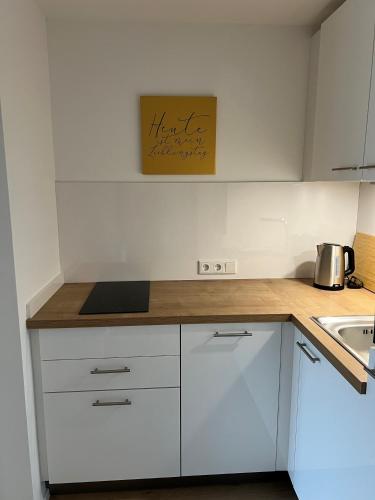 a kitchen with white cabinets and a counter top at Villa Berger in Döbriach