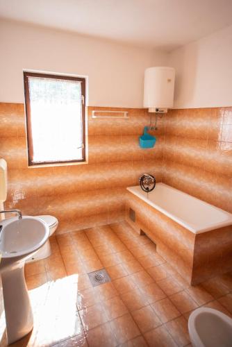 a bathroom with a tub and a sink at Bepo i Marija A2 in Pag