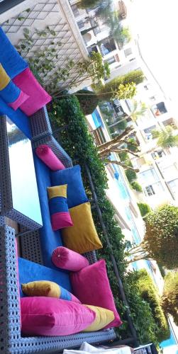 a staircase with colorful pillows on it with a building at Appartement avec piscine - Magic house in Mohammedia