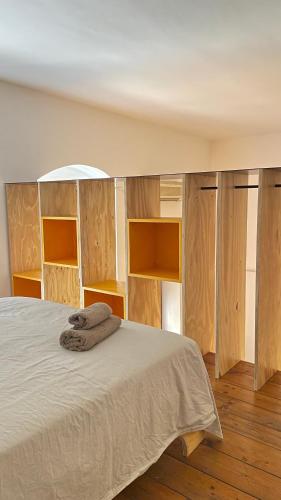 a bedroom with a bed with wooden shelving at Palazzo Verrone in Bari