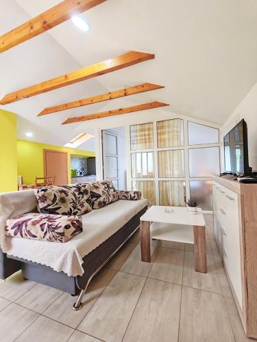 a living room with a bed and a table at Apartment Pengo in Neum