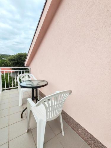 a balcony with two chairs and a table at Apartment Pengo in Neum