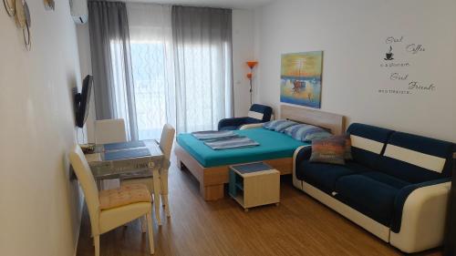 a small living room with a couch and a table at Your Home Montenegro in Dobra Voda