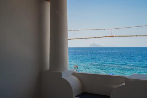 a view of the ocean from a room with a window at Archi Suite Canneto in Canneto