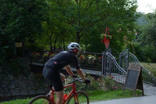 a man riding a bike next to a gate at Studio apartment Old Town Castle in Samobor