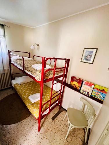 two bunk beds in a small room with a chair at Hotel Le Ponteil in Antibes