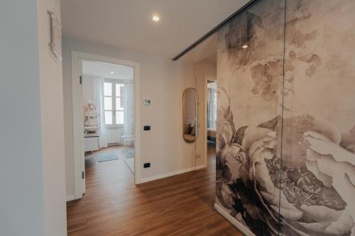 a hallway with a large painting on the wall at L'Altana City House in Brescia