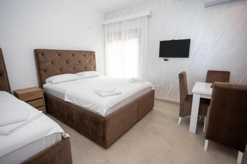 a bedroom with a bed and a desk and a television at Apartmani Milos - Meljine in Herceg-Novi