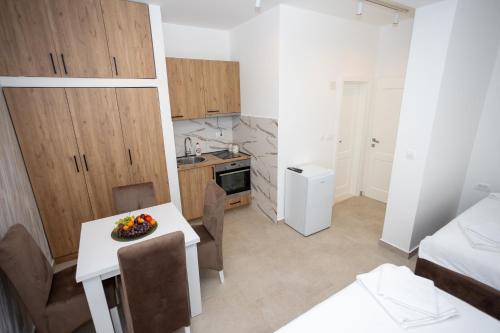 a kitchen and dining room with a table and chairs at Apartmani Milos - Meljine in Herceg-Novi